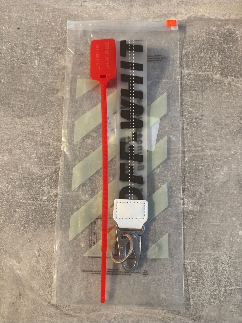 Off-White Clear Zip Bag with Red Zip Tie and Black and Clear Lanyard